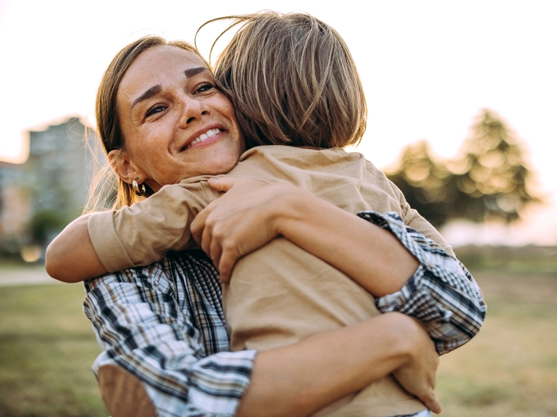 woman hugging another woman