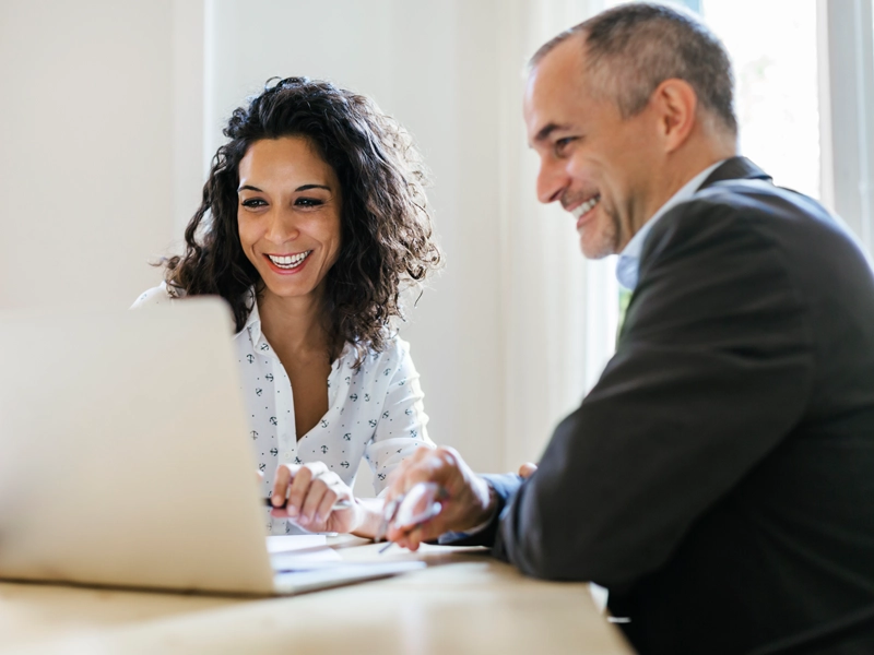 man and woman looking at laptop
