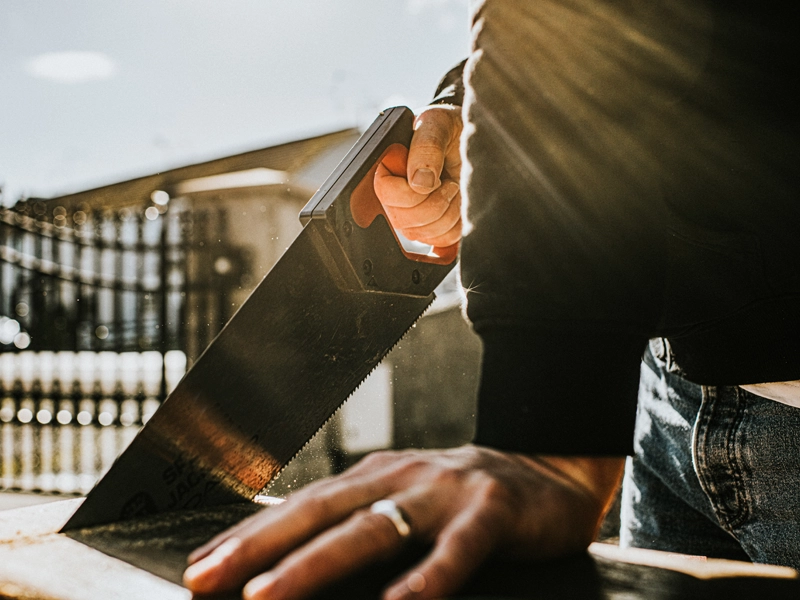 man sawing board